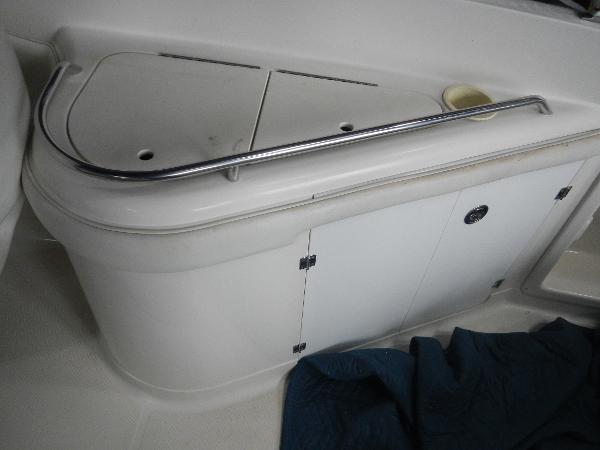 Slide: The Image of 2005 Monterey 248 LS boat interior storage compartment with railing. - 17