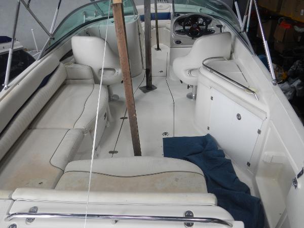 Slide: The Image of 2005 Monterey 248 LS boat interior with white seating and steering console. - 18