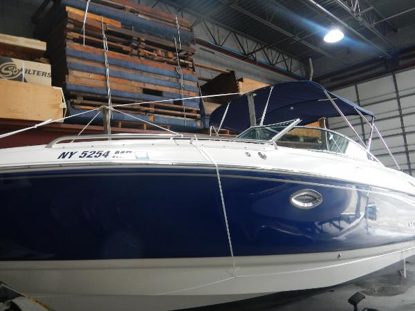 Slide: The Image of 2005 Monterey 248 LS boat in storage, blue and white exterior. - 4