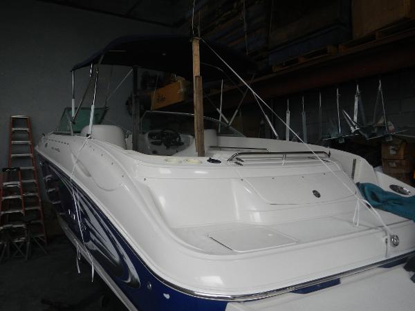 Slide: The Image of 2005 Monterey 248 LS boat in storage, white and blue exterior. - 6