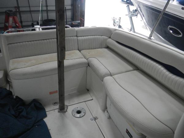 Slide: The Image of 2005 Monterey 248 LS boat interior with white cushioned seating. - 9