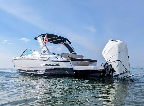 Slide: The Image of 2023 Monterey 275 SS boat on calm water with outboard motor. - 0