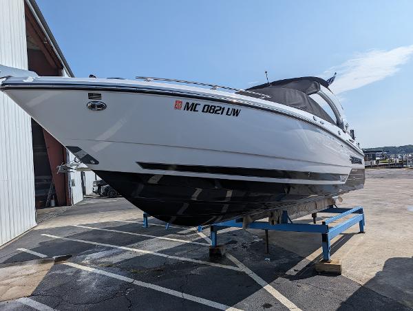 Slide: The Image of 2023 Monterey 275 SS boat on a stand in a marina. - 1