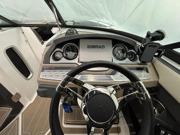 Slide: The Image of 2023 Monterey 275 SS boat dashboard with Simrad display and steering wheel. - 12