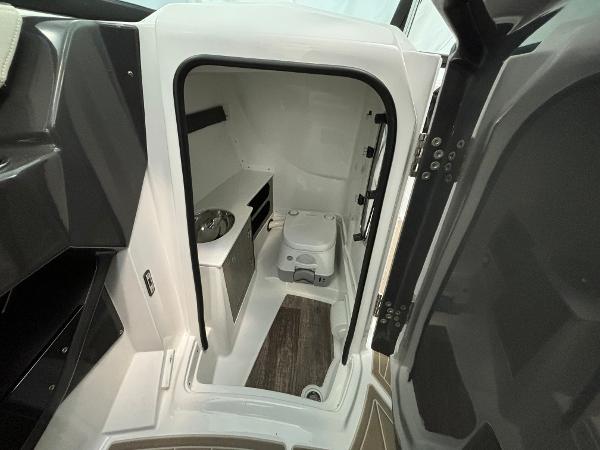Slide: The Image of 2023 Monterey 275 SS boat interior bathroom with toilet and sink. - 13