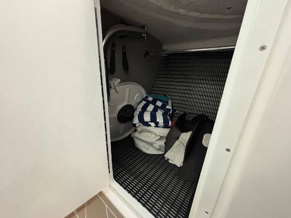 Slide: The Image of 2023 Monterey 275 SS boat interior storage compartment with various items. - 14