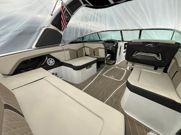 Slide: The Image of 2023 Monterey 275 SS boat interior with beige and black seating. - 4