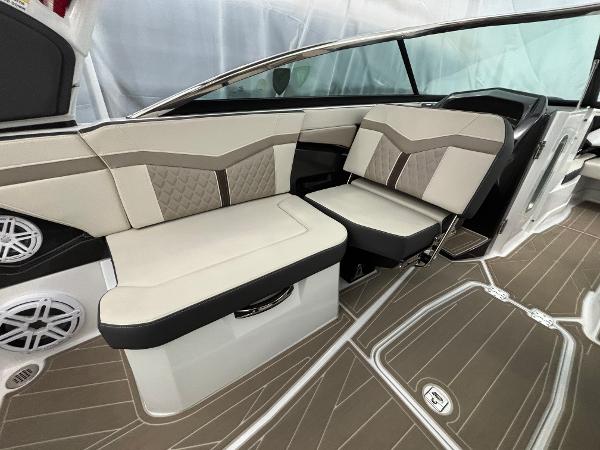 Slide: The Image of 2023 Monterey 275 SS boat interior with beige and brown seating. - 8