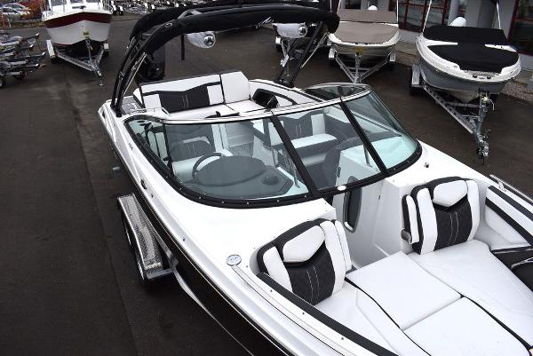 Slide: The Image of 2024 Monterey 275SS boat with sleek white and black interior, docked at a marina. - 16