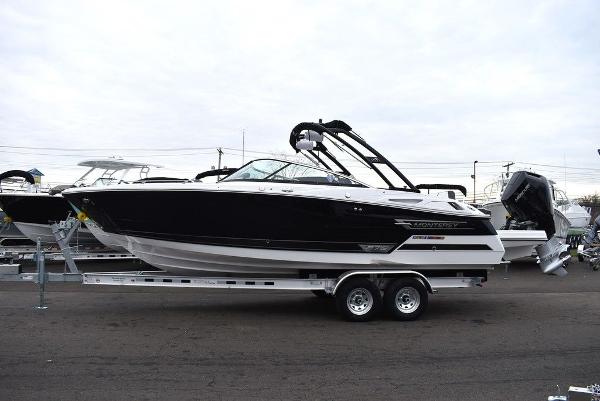 Slide: The Image of 2024 Monterey 275SS boat on a trailer, black and white exterior. - 2
