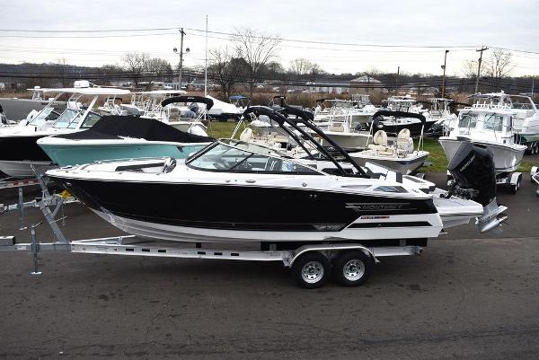 Slide: The Image of 2024 Monterey 275SS boat on a trailer in a marina. - 3