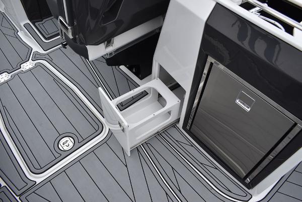 Slide: The Image of 2024 Monterey 275SS boat interior with gray flooring and built-in storage. - 49