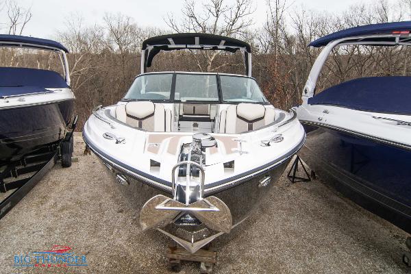 Slide: The Image of 2024 Monterey 278 SS boat displayed outdoors between two other boats. - 2