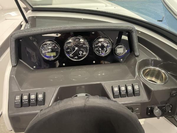 Slide: The Image of 2023 Monterey M-20 boat dashboard with gauges and control switches. - 11