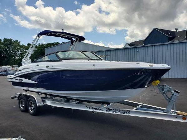 Slide: The Image of 2023 Monterey M-45 boat on a trailer, parked outdoors under a partly cloudy sky. - 3