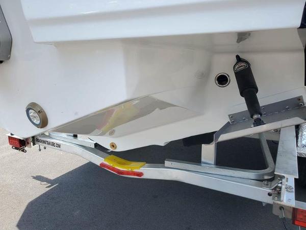 Slide: The Image of 2023 Monterey M-45 boat on trailer, rear view showing hull and trailer details. - 4