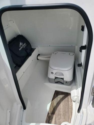 Slide: The Image of 2023 Monterey M-45 boat interior with portable toilet and storage compartment. - 8