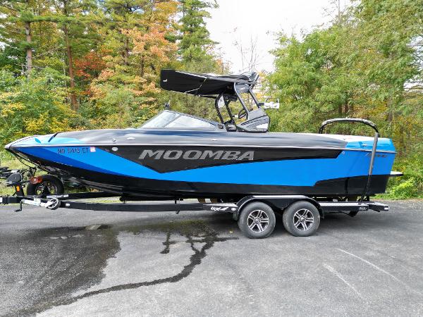 Slide: The Image of 2019 Moomba Makai boat on a trailer with blue and black design. - 1