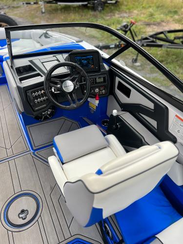 Slide: The Image of 2019 Moomba Makai boat interior with blue and white seating and modern dashboard. - 12