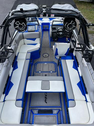 Slide: The Image of 2019 Moomba Makai boat interior with blue and white seating and advanced audio system. - 17