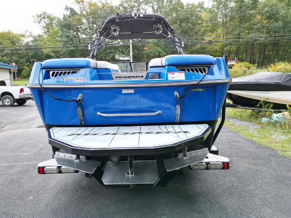 Slide: The Image of 2019 Moomba Makai blue boat rear view in outdoor setting. - 3