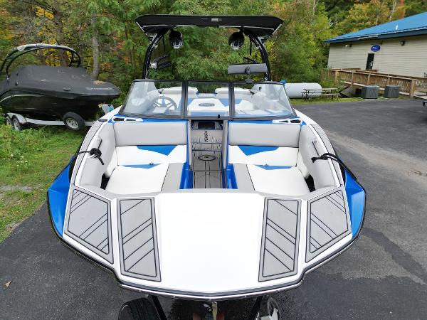 Slide: The Image of 2019 Moomba Makai boat with white and blue interior, docked on a paved surface. - 7