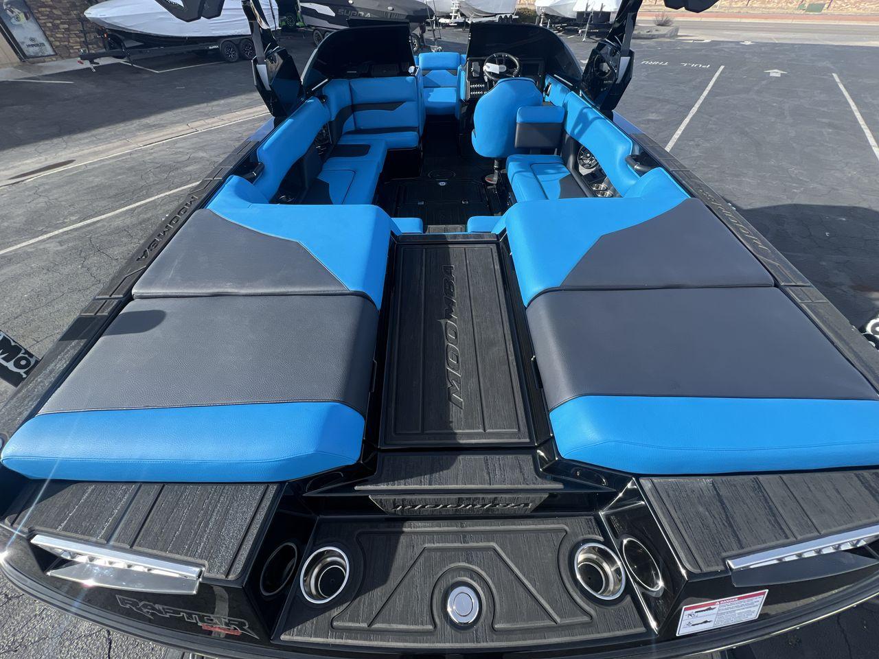 Slide: The Image of 2025 Moomba Mojo boat interior with blue and gray seating, showcasing spacious and modern design. - 27
