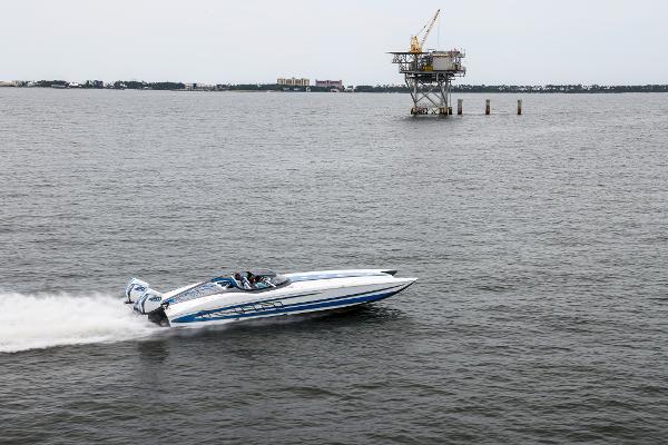 Slide: The Image of MTI 390X 2022 speedboat racing on open water near an offshore platform. - 3