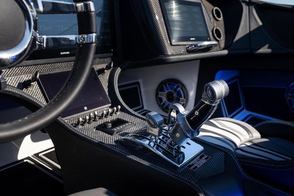 Slide: The Image of Interior of 2025 MTI 440X boat with advanced control panel and steering wheel. - 15