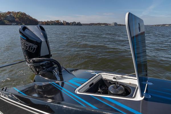 Slide: The Image of 2025 MTI 440X boat with open hatch and powerful outboard motor on a lake. - 19