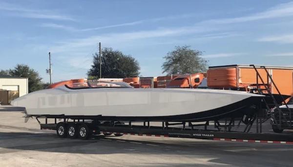 Slide: The Image of 2016 MTI 52' Pleasure boat on a trailer in a parking lot. - 1