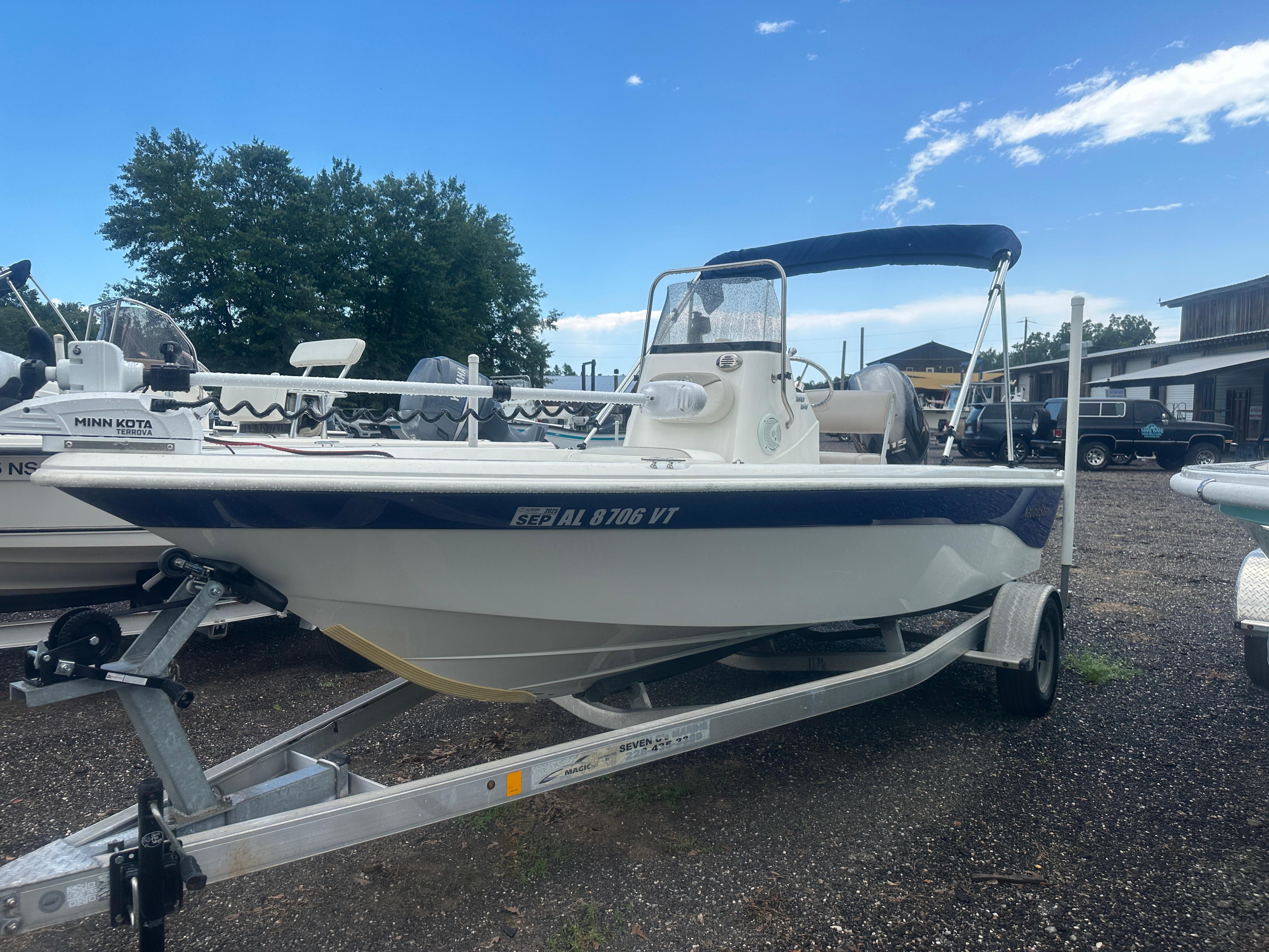 Slide: The Image of 2015 NauticStar 1810 NauticBay boat on trailer, parked outdoors under clear sky. - 0