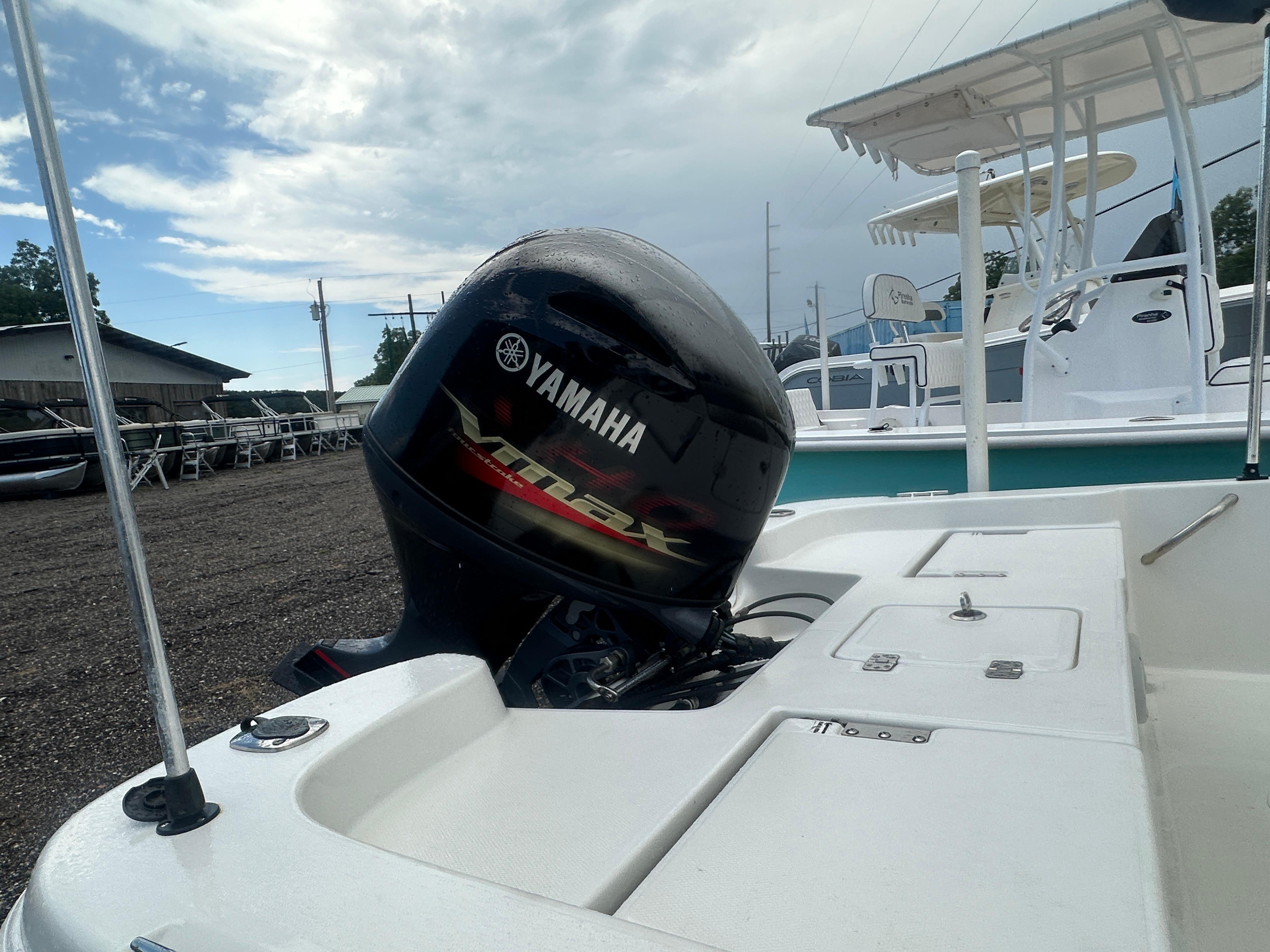Slide: The Image of 2015 NauticStar 1810 NauticBay boat with Yamaha outboard motor, docked under cloudy sky. - 10