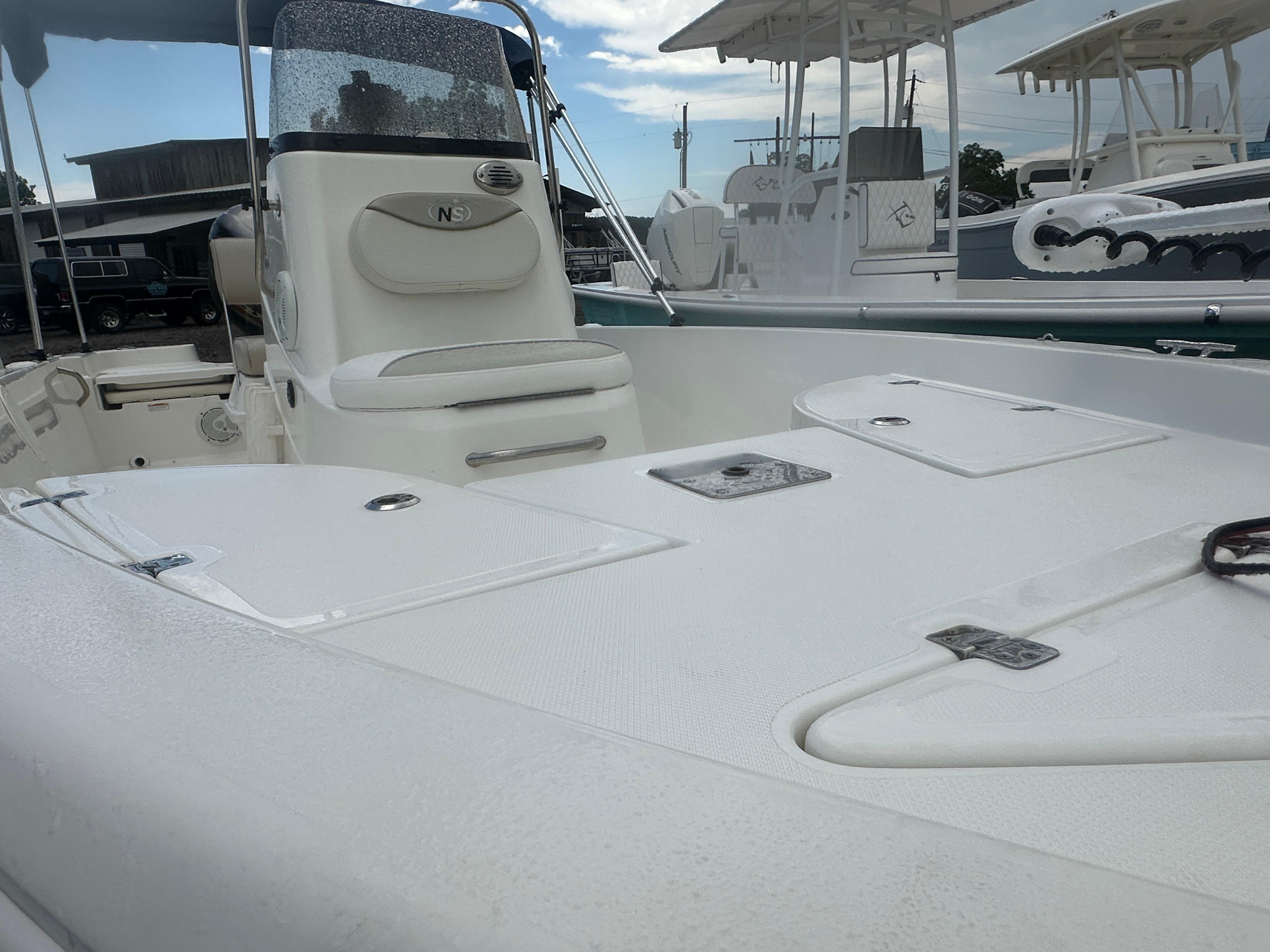 Slide: The Image of 2015 NauticStar 1810 NauticBay boat interior with seating and storage compartments. - 17