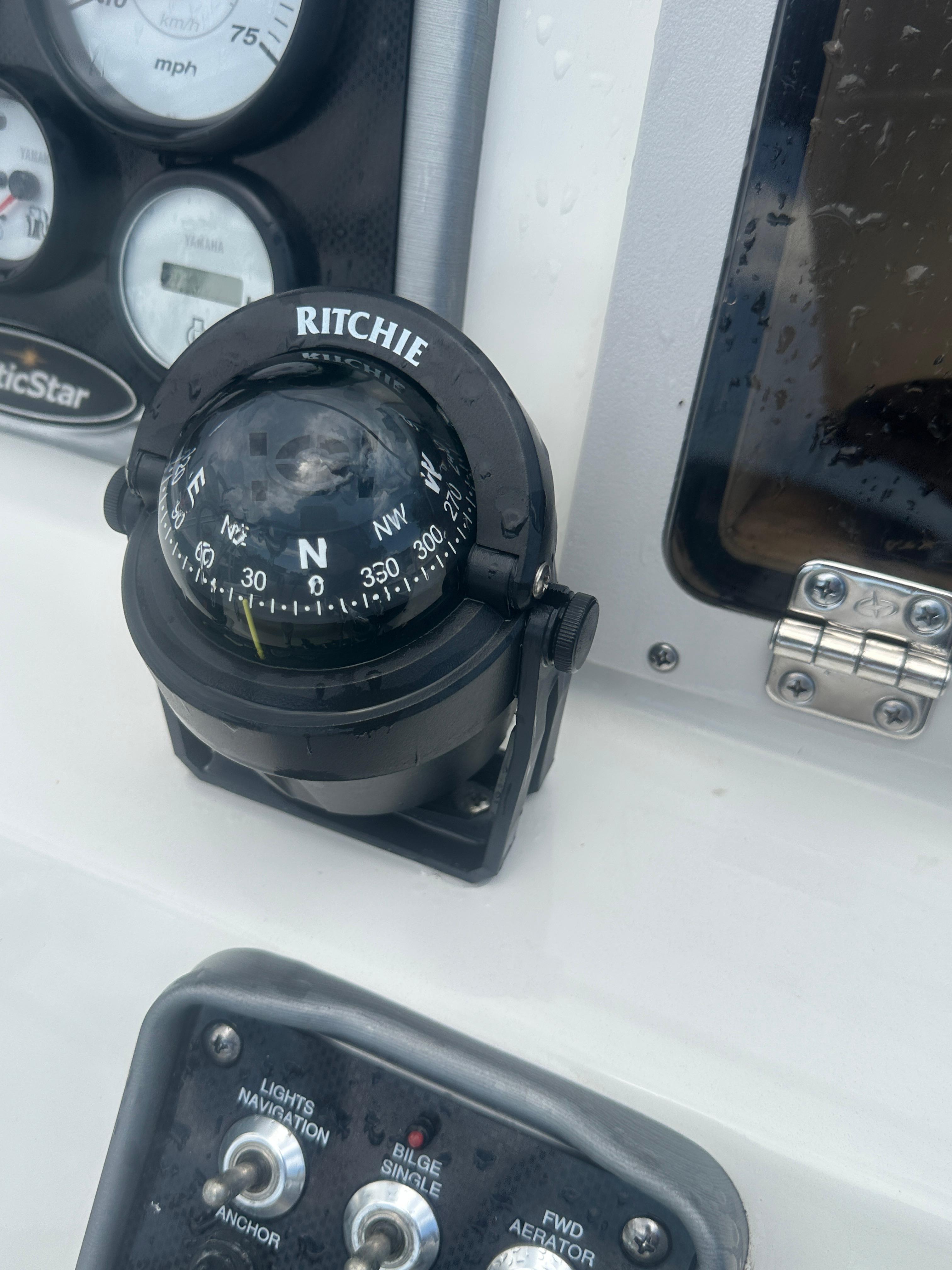 Slide: The Image of Compass and controls on 2015 NauticStar 1810 NauticBay boat dashboard. - 21