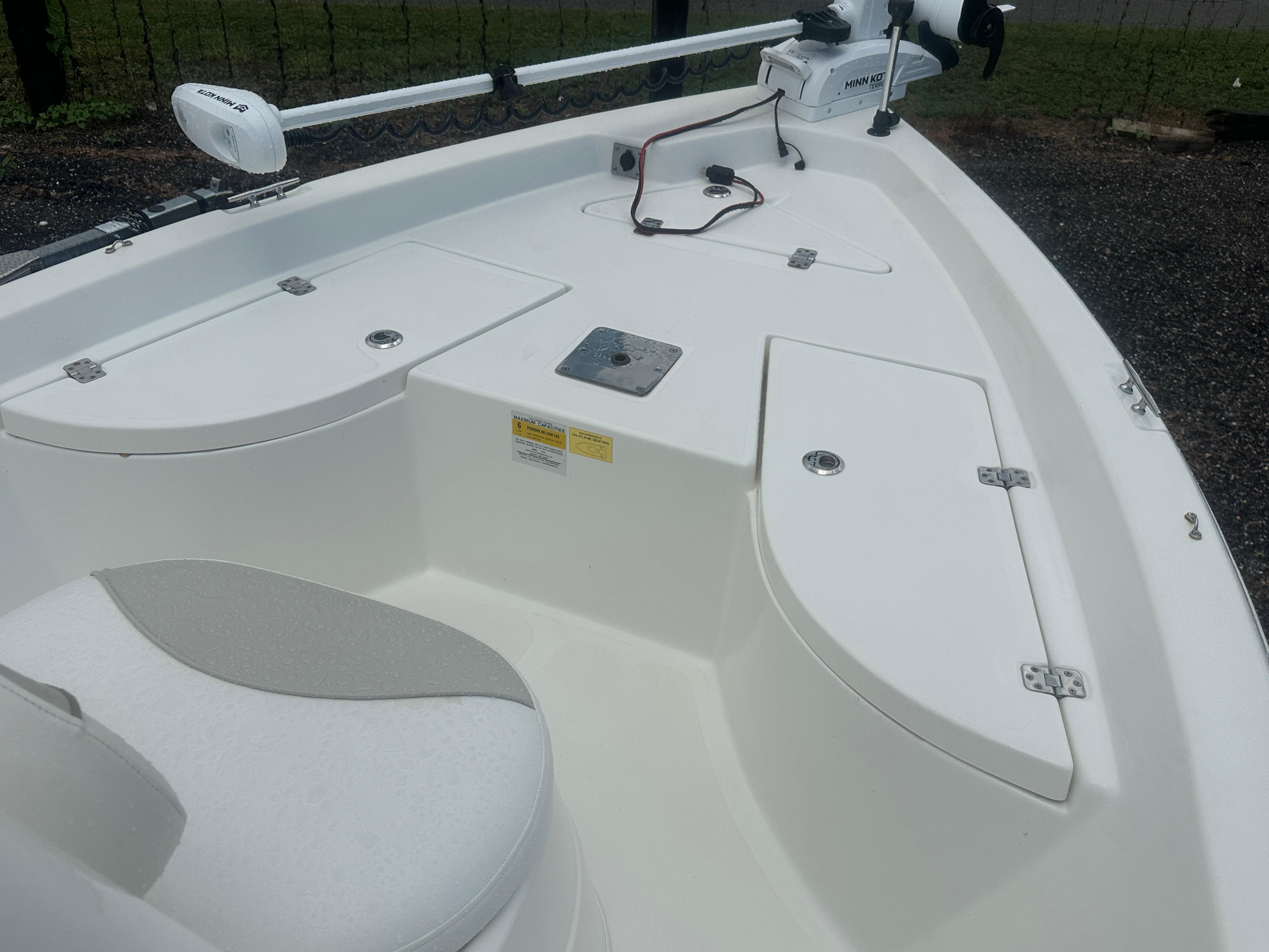 Slide: The Image of 2015 NauticStar 1810 NauticBay boat interior with storage compartments and Minn Kota trolling motor. - 23