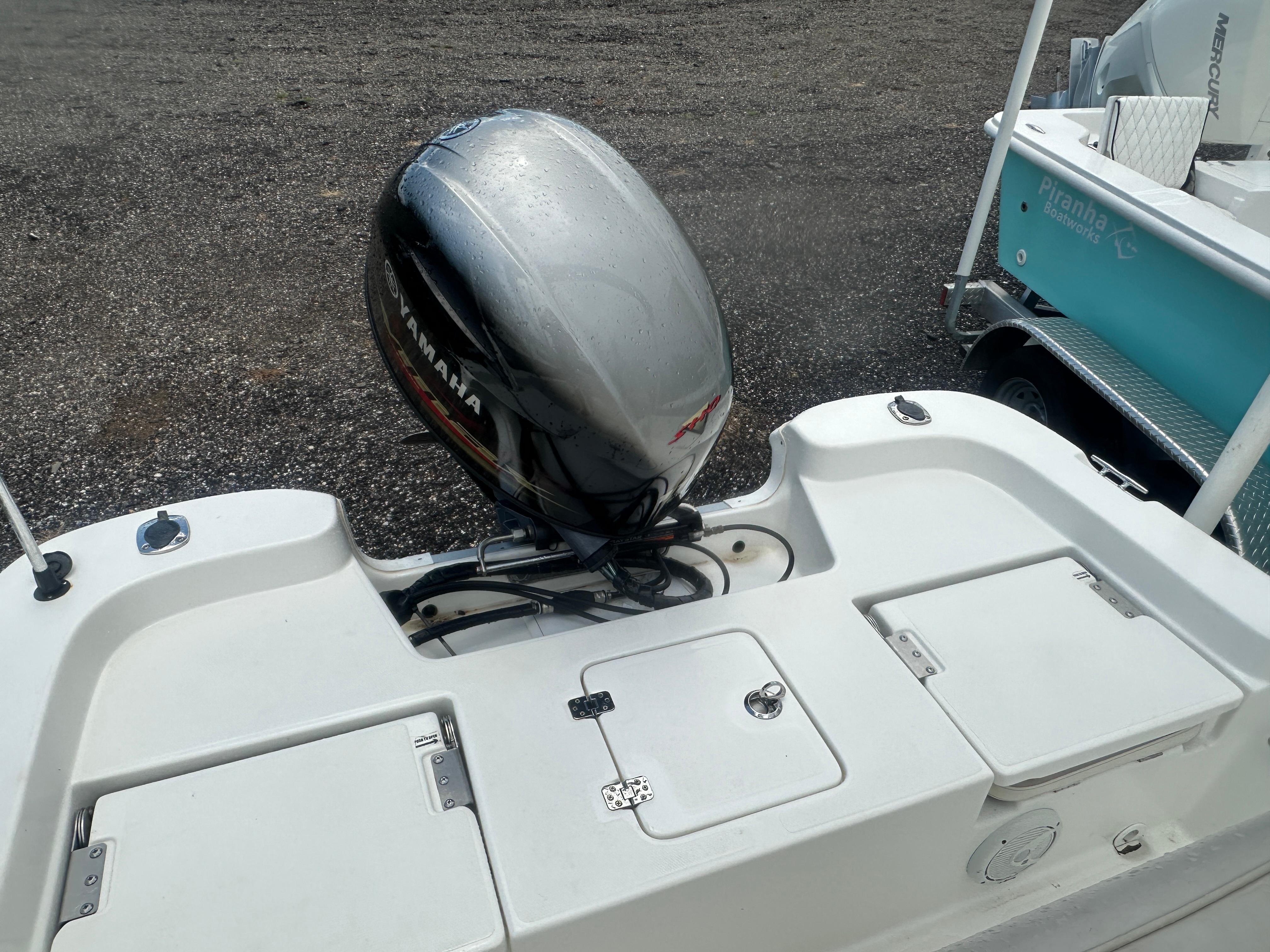Slide: The Image of 2015 NauticStar 1810 NauticBay boat with Yamaha outboard motor on a gravel surface. - 24