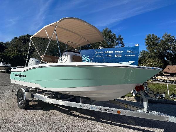 Slide: The Image of 2023 NauticStar 191 Hybrid boat on trailer with canopy, mint green hull. - 0