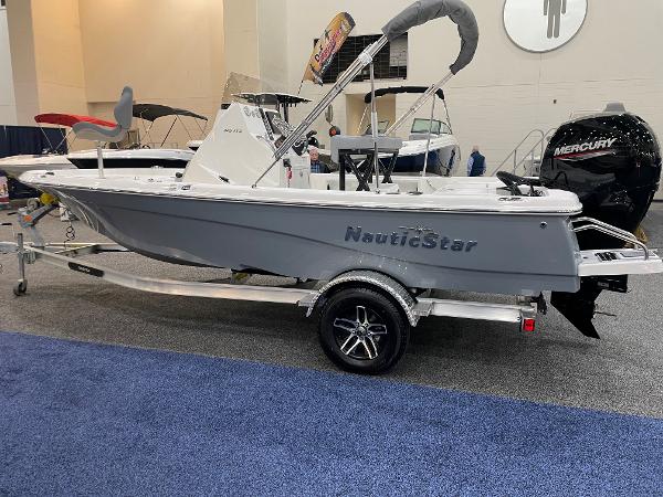 Slide: The Image of 2023 NauticStar 195 Bay boat on display with Mercury engine and trailer. - 3