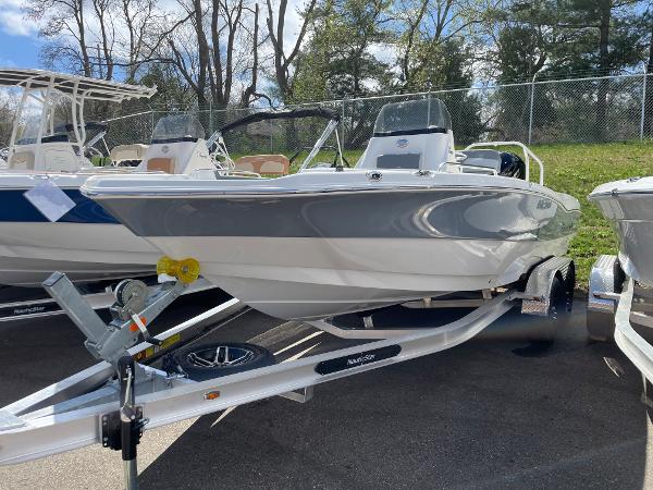 Slide: The Image of 2023 NauticStar 211 Hybrid boat on a trailer, ready for transport. - 0