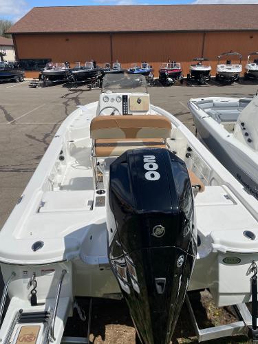 Slide: The Image of 2023 NauticStar 215 XTS boat with outboard motor in a dealership lot. - 3