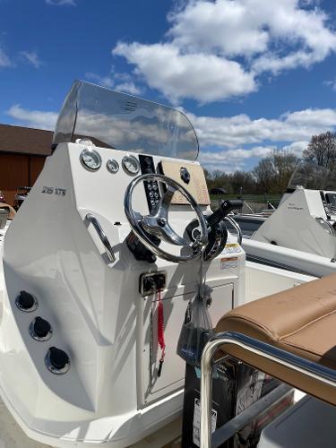 Slide: The Image of 2023 NauticStar 215 XTS boat console with steering wheel and gauges under a blue sky. - 4