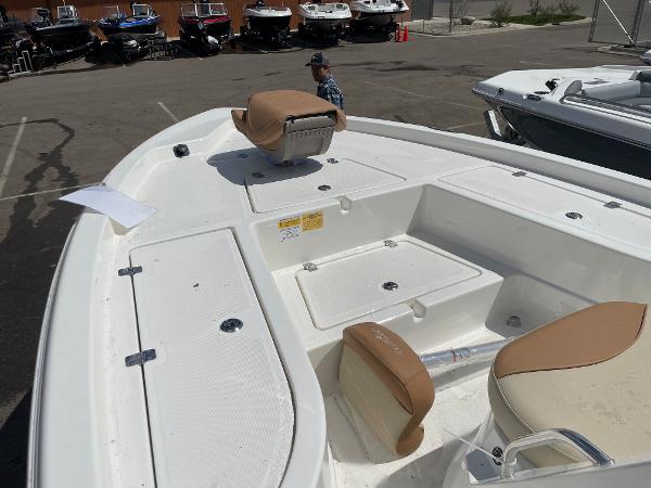 Slide: The Image of 2023 NauticStar 215 XTS boat interior with tan seats and storage compartments. - 6
