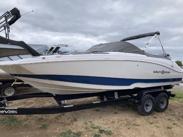 Slide: The Image of 2024 NauticStar 223 DC boat on trailer, side view. - 0