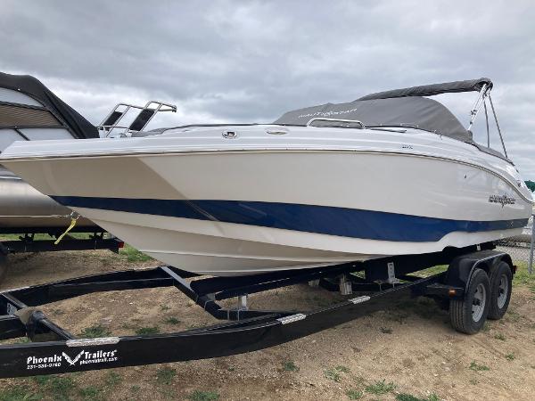 Slide: The Image of 2024 NauticStar 223 DC boat on a Phoenix Trailers trailer. - 1