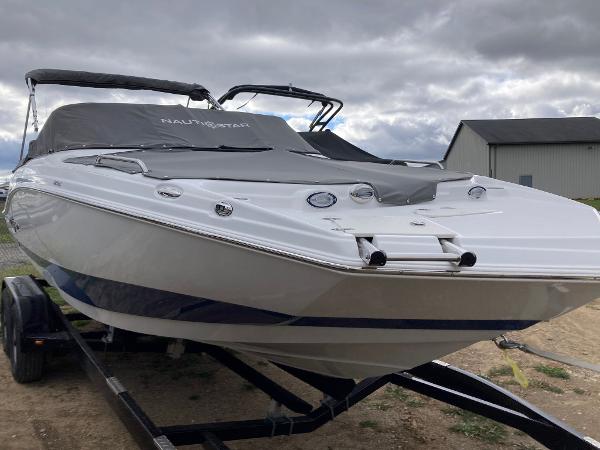 Slide: The Image of 2024 NauticStar 223 DC boat on trailer, covered and ready for transport. - 3