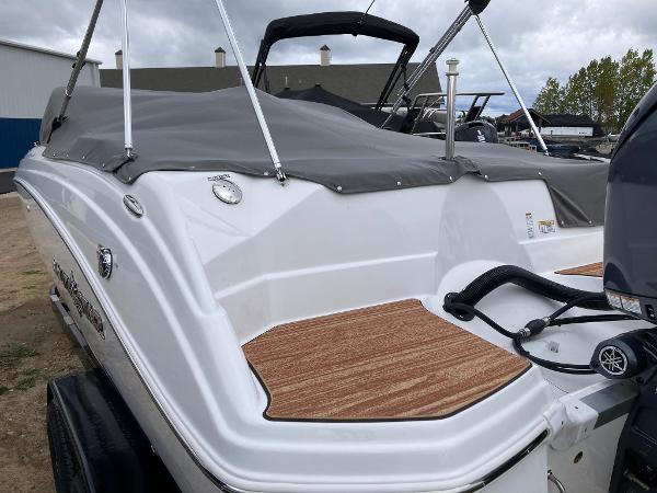 Slide: The Image of 2024 NauticStar 223 DC boat with covered deck and Yamaha outboard motor. - 7