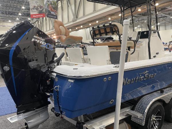 Slide: The Image of 2023 NauticStar 227 XTS boat with Mercury Pro XS engine at indoor exhibition. - 2