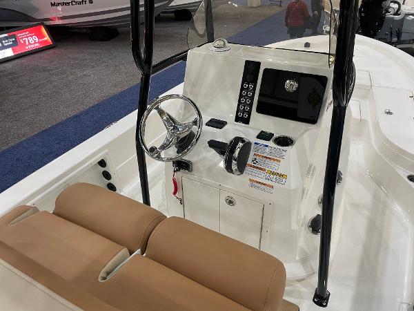 Slide: The Image of 2023 NauticStar 227 XTS boat console with steering wheel and controls. - 6