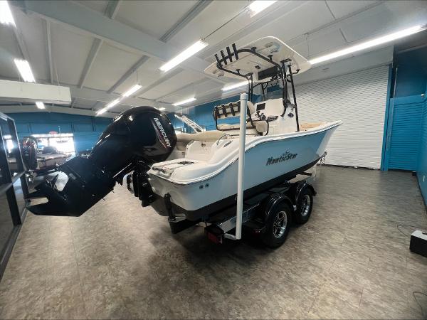 Slide: The Image of 2023 NauticStar 2302 Legacy boat on trailer in showroom. - 3